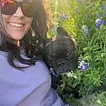 Glasses, Smile, Plant, Goggles, Vision Care, Dog, Sunglasses, Flower, Light, Carnivore, Eyewear, Gesture, Sunlight, Happy, Dog breed, Grass, Fawn, Companion dog, Black Hair, Beauty