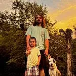 Sky, Cloud, Plant, Dog, People In Nature, Tree, Flash Photography, Happy, Gesture, Yellow, Shorts, Sunlight, Carnivore, Grass, Fawn, Leisure, T-shirt, Companion dog, Grassland, Fun