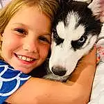 Smile, Skin, Dog, Eyes, Carnivore, Dog breed, Sled Dog, Iris, Happy, Fawn, Companion dog, Snout, Siberian Husky, Recreation, Fun, Furry friends, Grass, Sitting